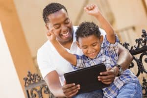 Dad and child playying on tablet