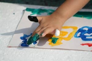 child finger painting