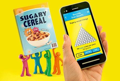 bright plasticine models holding up a box of sugary cereal and a phone with an app displayed