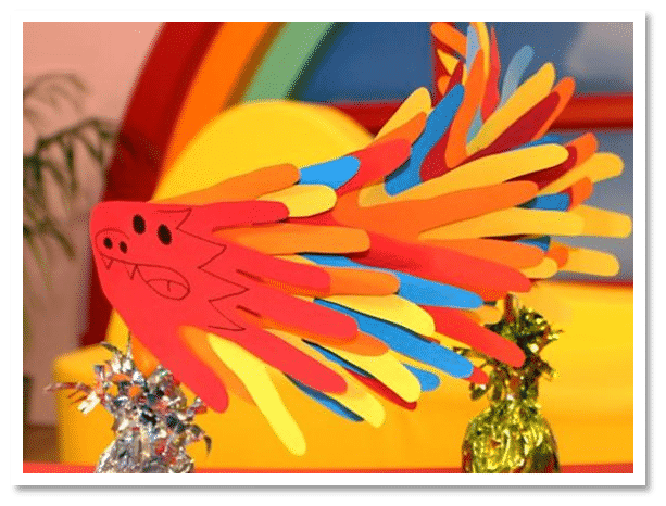Colourful paper dragon made with bright coloured paper