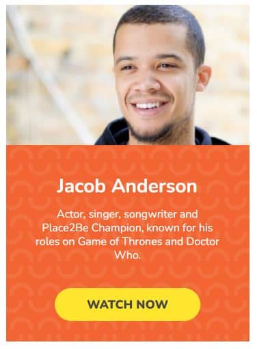 Actor, singer and songwriter Jacob Anderson smiling wearing a black top 